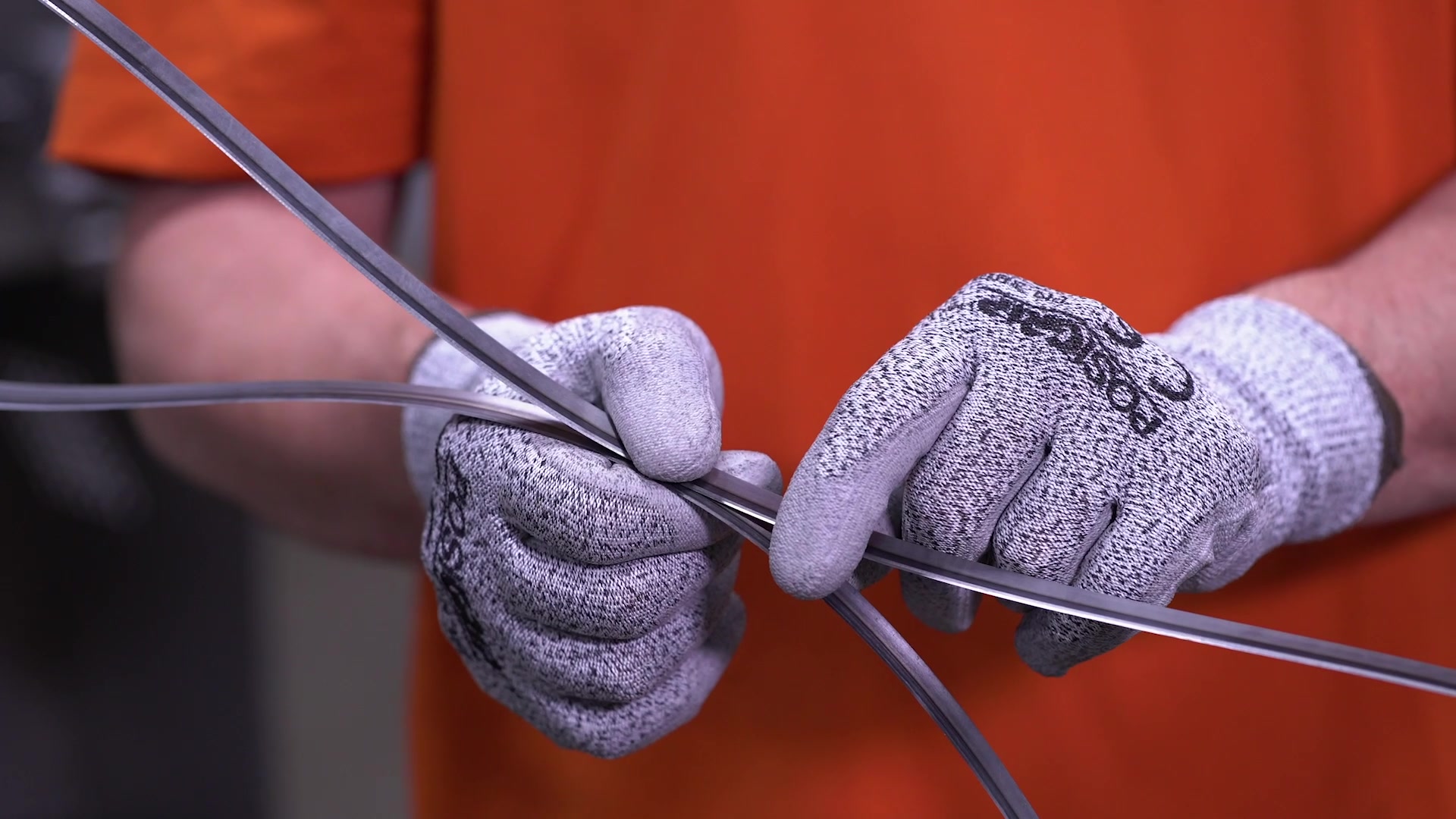A technician holds a Grote band blade with safety gloves.