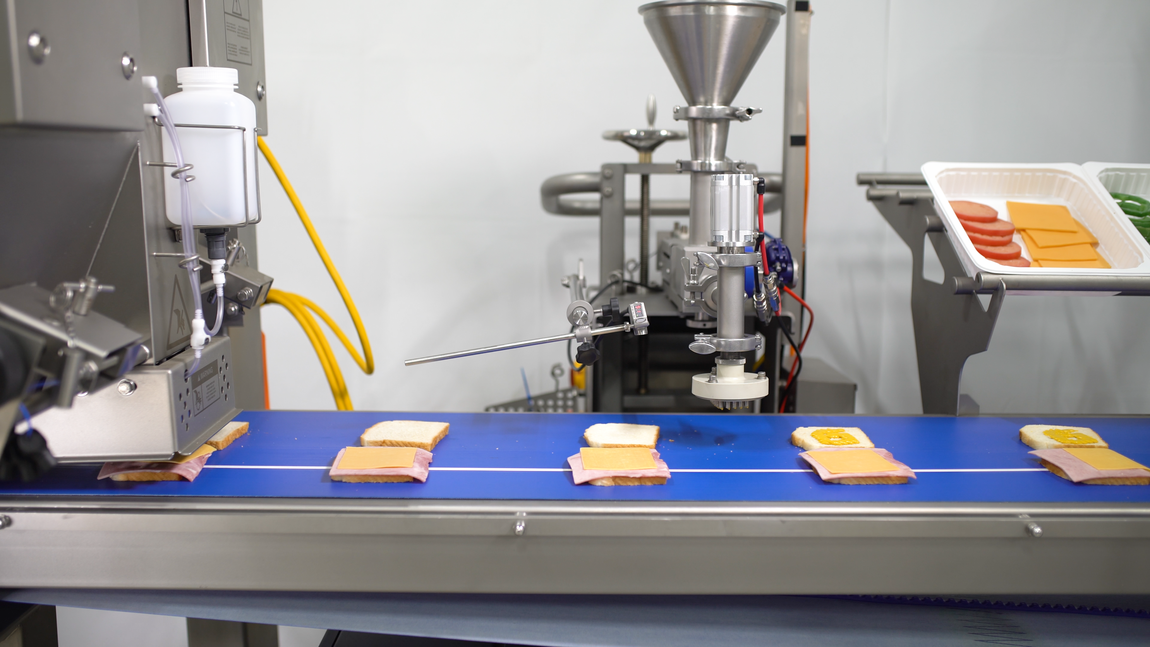 Grote sandwich assembly equipment line, including a depositor for mustard.